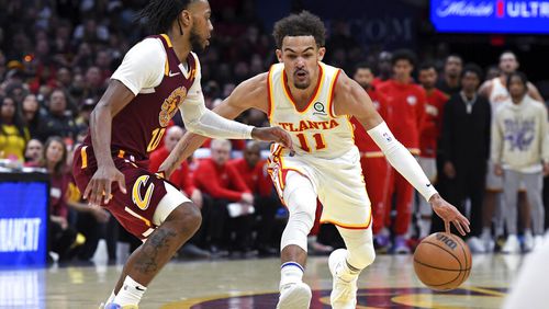 Atlanta Hawks' Trae Young (11) drives against Cleveland Cavaliers' Darius Garland (10) during the second half of an NBA play-in basketball game Friday, April 15, 2022, in Cleveland. (AP Photo/Nick Cammett)