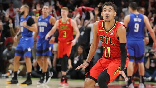 Hawks guard Trae Yound reacts to hitting a three pointer in the final minutes of a 103-99 victory over the Orlando Magic in the home opener Saturday, Oct. 26, 2019, in Atlanta.