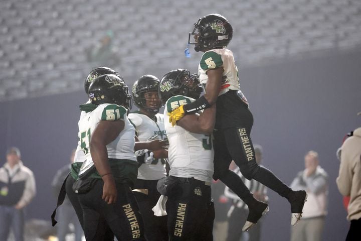 Langston Hughes wide receiver Armani Tookes (5) celebrates his receiving touchdown with offensive lineman Johnathan Hughley (55) during the first half against Buford in the Class 6A state title football game at Georgia State Center Parc Stadium Friday, December 10, 2021, Atlanta. JASON GETZ FOR THE ATLANTA JOURNAL-CONSTITUTION