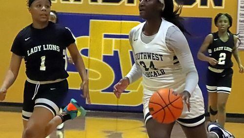 Southwest DeKalb's Aniyah Lee drives on King's Nazia Smith. Southwest and King have both qualified for the state tournament.