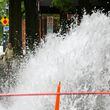 A water main break is seen at the corner of the corner of 11th Street and West Peachtree Street, Saturday, June 1, 2024, in Atlanta. A water main that ruptured, causing thousands to lose access to water around Atlanta, was repaired Saturday morning but water may take several hours to be restored. (Hyosub Shin / AJC)