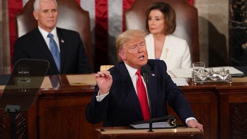 President Donald Trump delivers his State of the Union address at the U.S. Capitol in Washington on Tuesday. In the background, from left, Vice President Mike Pence and House Speaker Nancy Pelosi, D-Calif. (Erin Schaff/The New York Times)