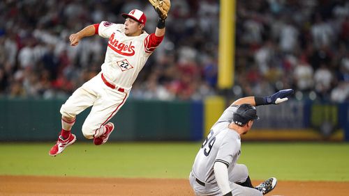 New York Yankees' Aaron Judge (99) steals second base ahead of a throw to Los Angeles Angels shortstop David Fletcher (22) during the ninth inning of a baseball game in Anaheim, Calif., Wednesday, Aug. 31, 2022. (AP Photo/Ashley Landis)