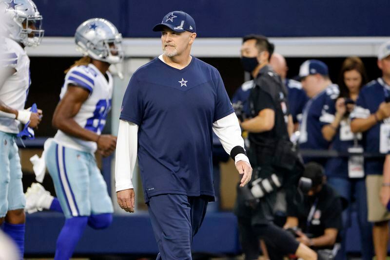 Dallas Cowboys Defensive Coordinator Dan Quinn walks on the field before the first half an NFL football game against the Philadelphia Eagles in Arlington, Texas, Monday, Sept. 27, 2021. (AP Photo/Ron Jenkins)