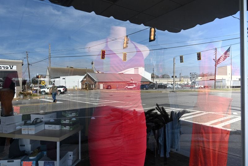 A rural south Georgia town of Rochelle is reflected on the show window of Kissed Beauty Boutique on First Avenue. Ten years ago, local Wilcox County high school students pushed for an official school prom, one that would be integrated. In the past, private proms were often segregated by race. (Hyosub Shin / Hyosub.Shin@ajc.com)