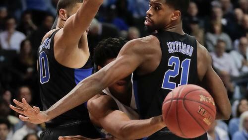 Duke forward Jayson Tatum (0) and Duke forward Amile Jefferson (21) double team North Carolina forward Isaiah Hicks as he passes off the ball in the second half of an NCAA college basketball game during the semifinals of the Atlantic Coast Conference tournament, Friday, March 10, 2017, in New York. (AP Photo/Julie Jacobson)