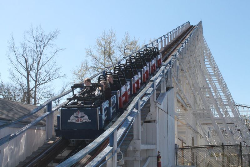 The Great American Scream Machine is running with riders facing backward at Six Flags Over Georgia for a limited time. Here the train is climbing up the first hill, with the front of the train facing downward. TOM KELLEY / TKELLEY@AJC.COM