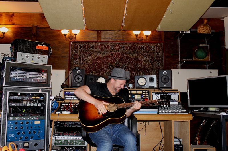 Kristian Bush jams in his Decatur studio. Photo: Ryon Horne/AJC.