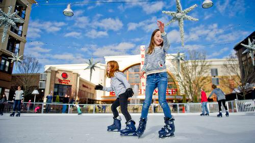 Abby Ostwald (right) and Emma Seher skate on the ice rink at Avalon in Alpharetta on Sunday, Nov. 30, 2014. The rink will be open most days through February 2015. JONATHAN PHILLIPS / SPECIAL