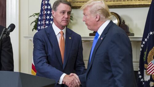 WASHINGTON, DC - AUGUST 2: (AFP OUT) U.S. President Donald Trump shakes hands with Sen. David Perdue (R-GA) during an announcement on the introduction of the Reforming American Immigration for a Strong Economy (RAISE) Act in the Roosevelt Room at the White House on August 2, 2017 in Washington, DC. The act aims to overhaul U.S. immigration by moving towards a "merit-based" system.  (Photo by Zach Gibson - Pool/Getty Images)