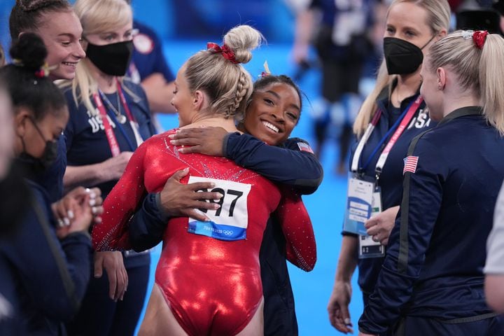 Mykayla Skinner of United States gets a hug from teammate Simone Biles after her performance on the beam during women's artistic gymnastic qualifications at Ariake Gymnastics Center in Tokyo on Sunday, July 25, 2021. (Chang W. Lee/The New York Times)