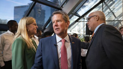 Gov. Brian Kemp, center, first lady of Georgia Marty Kemp, left, and WSB radio host Shelley Wynter, right, during a campaign event at Venture X Buckhead in Atlanta, on Oct. 5, 2022. Since a report in The Daily Beast said Herschel Walker, the Republican Senate candidate in Georgia, paid for an abortion in 2009, Kemp has offered no specific support nor condemnation. (Nicole Craine/The New York Times)