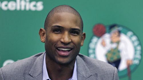 Boston Celtics forward Al Horford smiles during a media availability at the team's practice facility, Friday, July 8, 2016, in Waltham, Mass. Horford agreed to a four-year, $113 million deal with the Celtics as an unrestricted free agent, ending nearly ten years with the Atlanta Hawks. (AP Photo/Charles Krupa)
