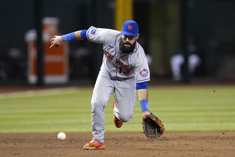 New York Mets third baseman Luis Guillorme fields a grounder hit by Arizona Diamondbacks' Gabriel Moreno, who was out at first during the eighth inning of a baseball game Thursday, July 6, 2023, in Phoenix. The Mets won 9-0. (AP Photo/Ross D. Franklin)