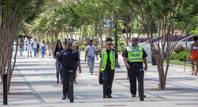 Three Clark Atlanta University police walk through the campus on the first day of classes on Aug. 21, 2019, near where a shooting injured several students. (Phil Skinner / AJC file photo)