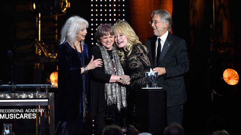 Honoree Dolly Parton accepts the 2019 MusiCares Person of the Year Award from (L-R) Emmylou Harris, Linda Ronstadt, and Recording Academy and MusiCares President/CEO Neil Portnow onstage during MusiCares Person of the Year honoring Dolly Parton at Los Angeles Convention Center on February 8, 2019 in Los Angeles, California.