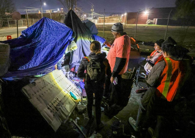 Todd Rick, 31, who is homeless, emerges from an encampment as Jose Sandoval, the director of homeless at Frontline Response Atlanta, center right, and volunteers participate in the PIT, (Point-In-Time) count near the Mechanicsville neighborhood, Monday, Jan. 23, 2023, in Atlanta. The group of volunteers and staff from supporting agencies where participating in the PIT count, a practice mandated by the federal government that tallies people who were homeless on one night in January of each year. Jason Getz / Jason.Getz@ajc.com)
