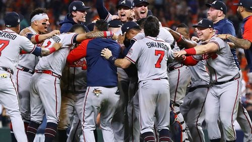 The Braves charge the mound to celebrate beating the Astros in Game 6 to win the World Series on Nov. 2 in Houston. Players are scheduled to receive their championship rings Saturday. (Curtis Compton / Curtis.Compton@ajc.com)