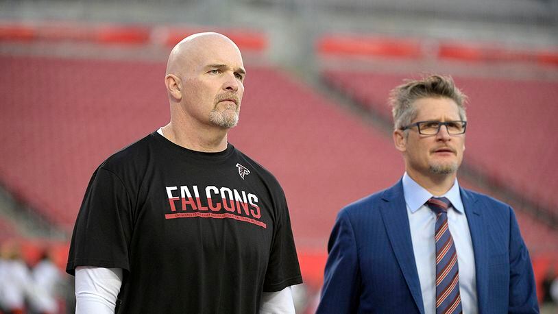 Atlanta Falcons head coach Dan Quinn (left), and general manager Thomas Dimitroff walk on the field before the game against the Tampa Bay Buccaneers Monday, Dec. 18, 2017, in Tampa, Fla.