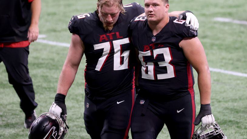 Starting right guard Chris Lindstrom (right) had his $13.2 million fifth-year option picked up by the Falcons on Monday. The team declined starting right tackle Kaleb McGary’s fifth-year option. (Jason Getz/for the AJC)
