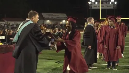 Hannah Michelle Turner receives her diploma from Principal Bo Ford at Brookwood High School's graduation ceremony. (Handout)