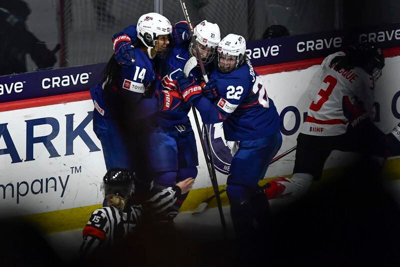 United States forward Hilary Knight, center, celebrates with forwards Laila Edwards, left, and Tessa Janecke after scoring against Canada during the third period in the final at the IIHF Women's World Hockey Championships in Utica, N.Y., Sunday, April 14, 2024. (AP Photo/Adrian Kraus)