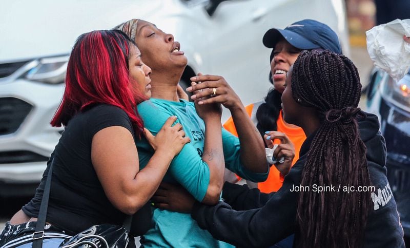 Sanmarian McClain (center) mourns the loss of her daughter Jessica Daniels, who was killed when a stray bullet flew into her home while she was sleeping.