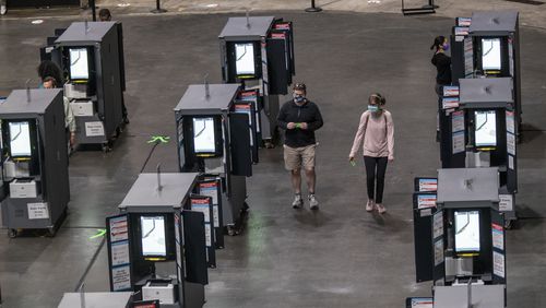 Fulton County residents use voting machines to cast their ballotst on the floor of State Farm Arena during the fourth day of early voting in Georgia, Thursday, October 15, 2020.  (Alyssa Pointer / Alyssa.Pointer@ajc.com)