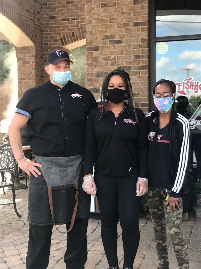 During the pandemic, Catfish Hox owners Philip (left) and Vivian Creasor (center) have been able to retain their six employees, including Maia Jackson (right). LIGAYA FIGUERAS / LIGAYA.FIGUERAS@AJC.COM