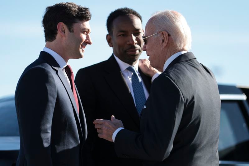 Democratic U.S. Sen. Jon Ossoff, left, Atlanta Mayor Andre Dickens, center, and President Joe Biden talk during the president's visit to Atlanta in January. Democrats are trying to link Georgia's boom in green energy jobs to Biden's climate initiatives. (Oliver Contreras/The New York Times)