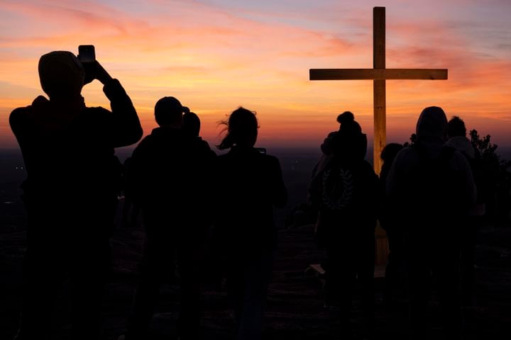 People gather around the cross during Easter sunrise service on top of Stone Mountain on Sunday, March 31, 2024.   (Ben Gray / Ben@BenGray.com)