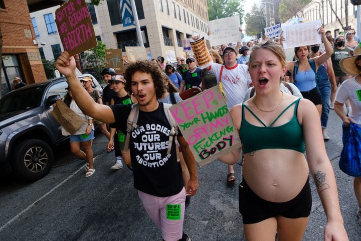 (L-R) Elijah Rudd and his pregnant partner Mia Knighton attend an abortion rights rally in Atlanta on Friday, June 24, 2022. The protest follows the Supreme Court’s overturning of Roe v Wade. (Arvin Temkar / arvin.temkar@ajc.com)