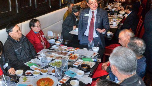 David Kim (standing), the son of South Korean immigrants, speaks with guests and supporters during a recent campaign luncheon. A Democrat, he is running in the 7th Congressional District rooted in Gwinnett and Forsyth counties. (Photo by Chris Hunt/Special)