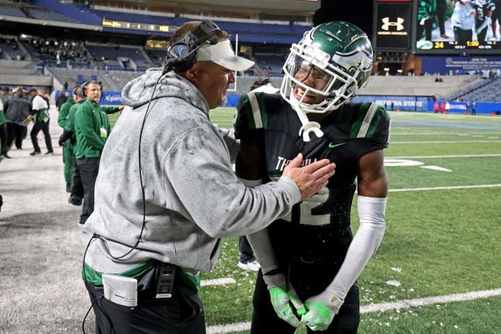 Collins Hill head coach Lenny Gregory, left, celebrates with wide receiver Travis Hunter (12) in the closing minute of their 24-8 win against Milton in the Class 7A state title football game at Georgia State Center Parc Stadium Saturday, December 11, 2021, Atlanta. JASON GETZ FOR THE ATLANTA JOURNAL-CONSTITUTION
