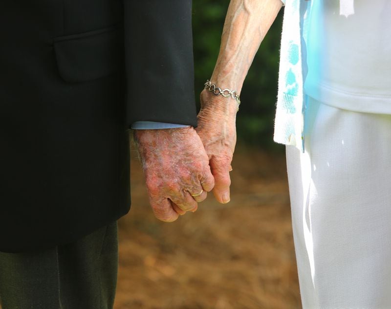 2014: Jimmy and Rosalynn Carter hold hands as they leave the Maranatha Baptist Church following church services in Plains. (Curtis Compton / ccompton@ajc.com)