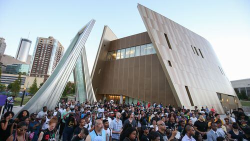 Demonstrators gather at the Center for Civil and Human Rights before marching through downtown Atlanta, Friday, Sept. 23, 2016 in response to the police shooting deaths of Terence Crutch in Tulsa, Okla. and Keith Lamont Scott in Charlotte, N.C. (AP Photo/Branden Camp)