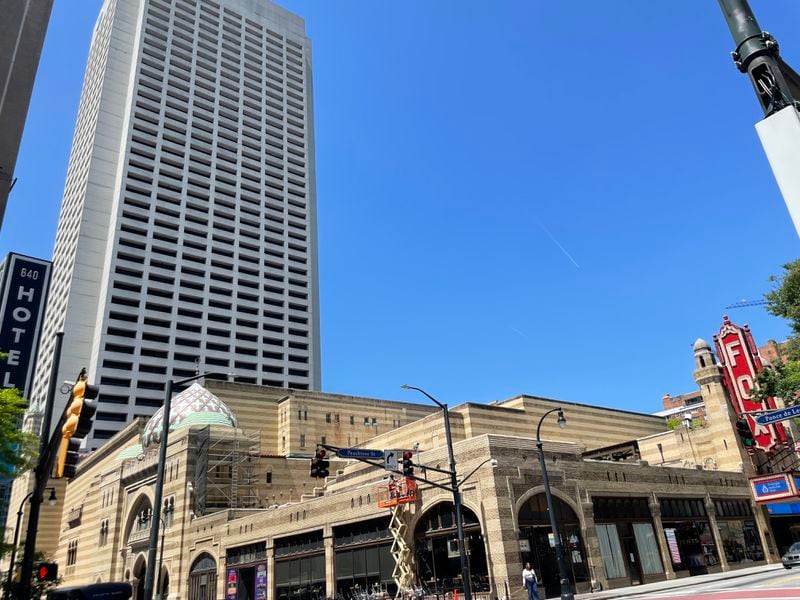 The Tower Square building, completed in 1982 and now standing empty, hovers about the Fox Theatre, which it almost replaced. (Bill Torpy/btorpy@ajc.com)