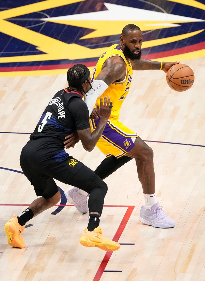 Los Angeles Lakers forward LeBron James (23) is guarded by Denver Nuggets guard Kentavious Caldwell-Pope (5) during the second half in Game 2 of an NBA basketball first-round playoff series Monday, April 22, 2024, in Denver. (AP Photo/Jack Dempsey)