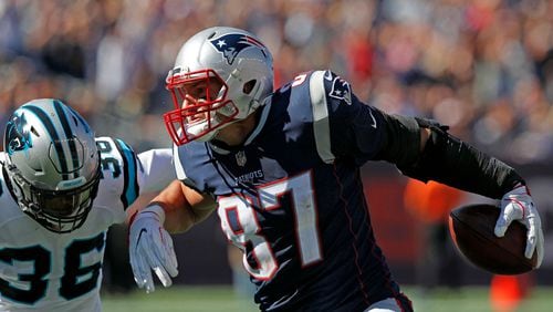 Patriots tight end Rob Gronkowski tries to fend off Panthers safety Demetrious Cox after a reception during their game at Gillette Stadium on Oct. 1.