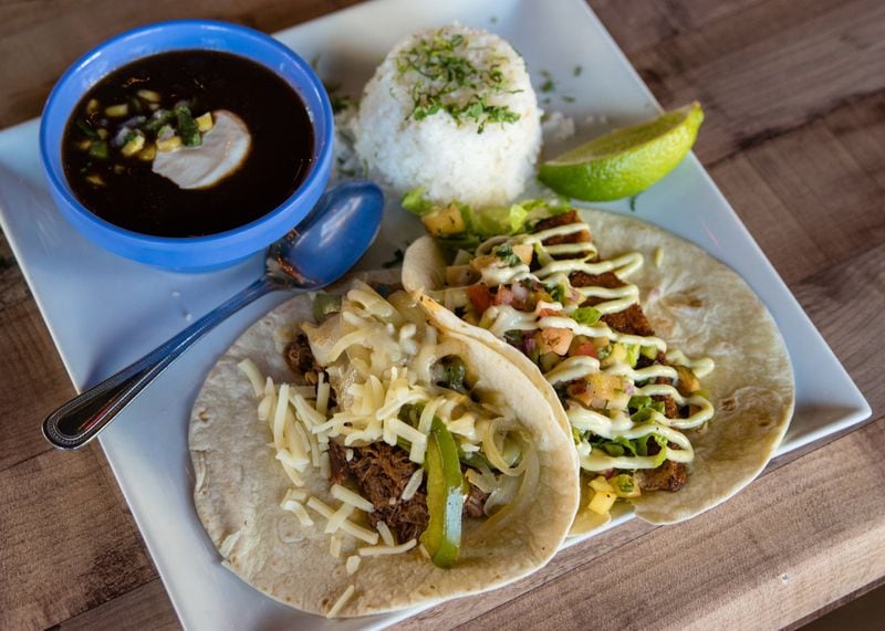 A taco combo from Cabo Cantina in Buckhead served with rice and beans. On the left, a short rib taco and on the right, fried catfish. CONTRIBUTED BY HENRI HOLLIS