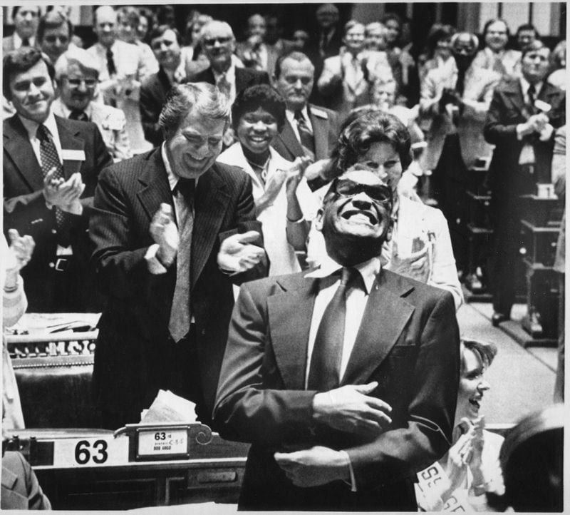 Ray Charles enjoys the ovation he received from a joint session of the Georgia Legislature. The Assembly made his version of "Georgia on My Mind" the official state song after he sang it to the session in 1979. AP FILE