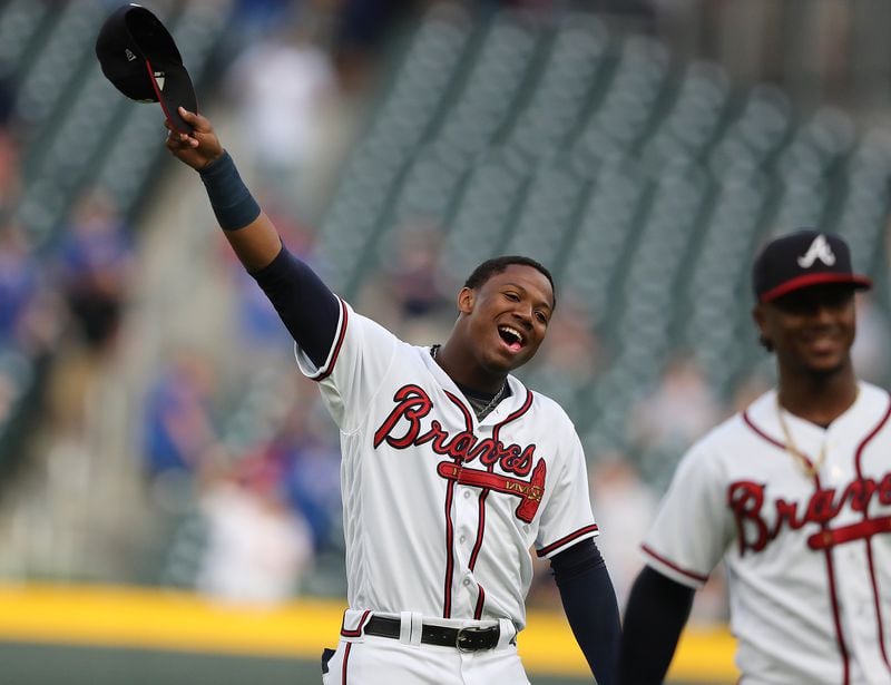 Ronald Acuna Jr. waves to fans as he takes the field to play the Chicago Cubs on Wednesday, May 16, 2018, in Atlanta.   Curtis Compton/ccompton@ajc.com