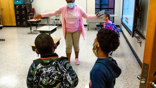 Jackson Elementary School teacher Darlene Willims greets students as they return for in-person learning in Clayton County on April 12. Clayton County was the last metro Atlanta district to bring students back to class for face-to-face instruction. STEVE SCHAEFER FOR THE ATLANTA JOURNAL-CONSTITUTION