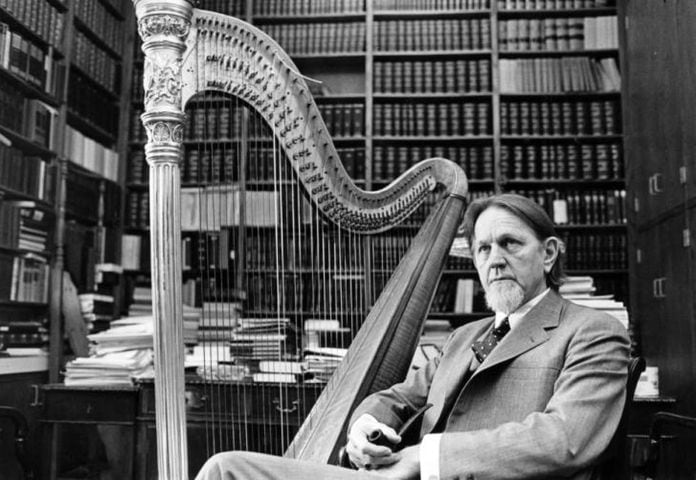 Bobby Lee Cook in office with harp 1984