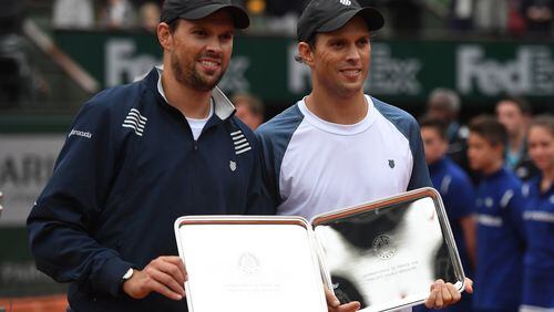 PARIS, FRANCE - JUNE 04: Runners Mike Bryan and Bob Bryan of the United States pose with the trophies won during the Men's Doubles final match against Feliciano Lopez and Marc Lopez of Spain on day fourteen of the 2016 French Open at Roland Garros on June 4, 2016 in Paris, France. (Photo by Dennis Grombkowski/Getty Images)