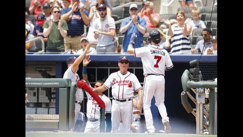 Atlanta Braves  shortstop Dansby Swanson is congratulated after scoring during a recent game.
