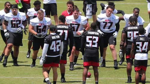 Falcons offensive lineman Bryce Hargrove (from left), Ryan Neuzil, Drew Dalman, Jalen Mayfield and tight end Kyle Pitts line up against the defense to run a play during rookie minicamp Friday, May 14, 2021, in Flowery Branch.  (Curtis Compton / Curtis.Compton@ajc.com)