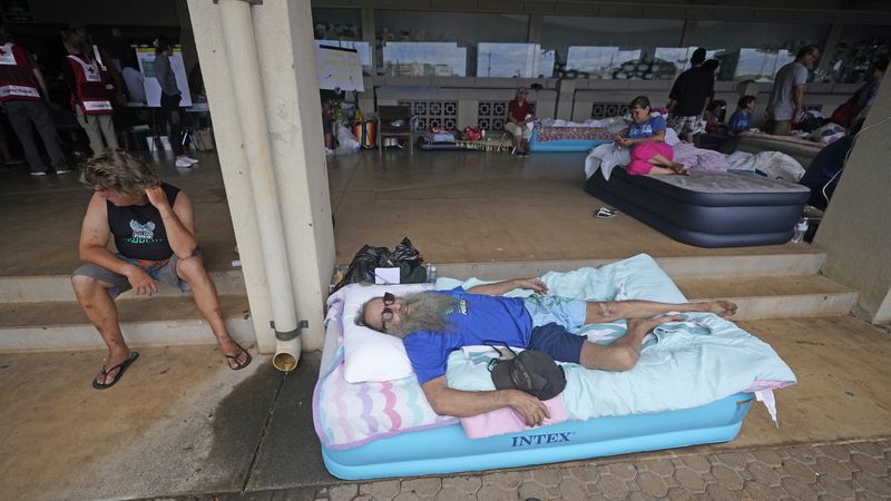 FILE - Thomas Leonard lies on an air mattress at an evacuation center at the War Memorial Gymnasium after his Lahaina apartment was destroyed by wildfire, Thursday, Aug. 10, 2023, in Wailuku, Hawaii. (AP Photo/Rick Bowmer, File)