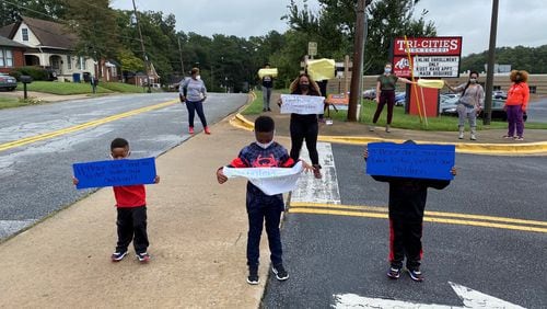 Fulton County Schools teachers and children protest the district's plan of returning to face-to-face instruction with a walkout during lunch on Thursday, Sept. 17, 2020.
