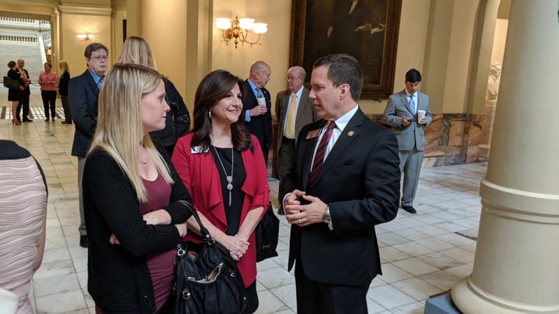 May 8, 2018, Atlanta -- Child sexual abuse survivor Erin Merryn, of Illinois, (left) encouraged Rep. Wes Cantrell, R-Woodstock, (right) to write a new law requiring schools to teach students starting in kindergarten about sexual abuse. She talks with the lawmaker and his wife, Jane, at the Gold Dome after Gov. Nathan Deal signed Senate Bill 401 into law.